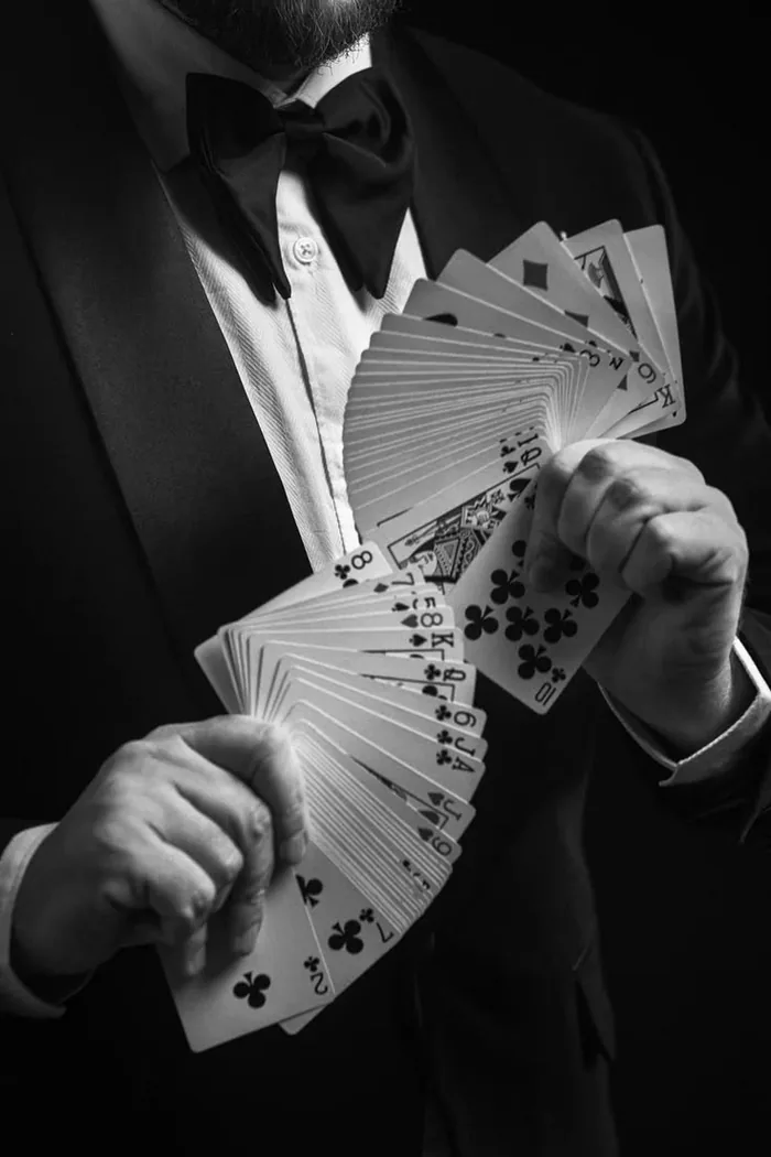 A magician fanning a deck of playing cards